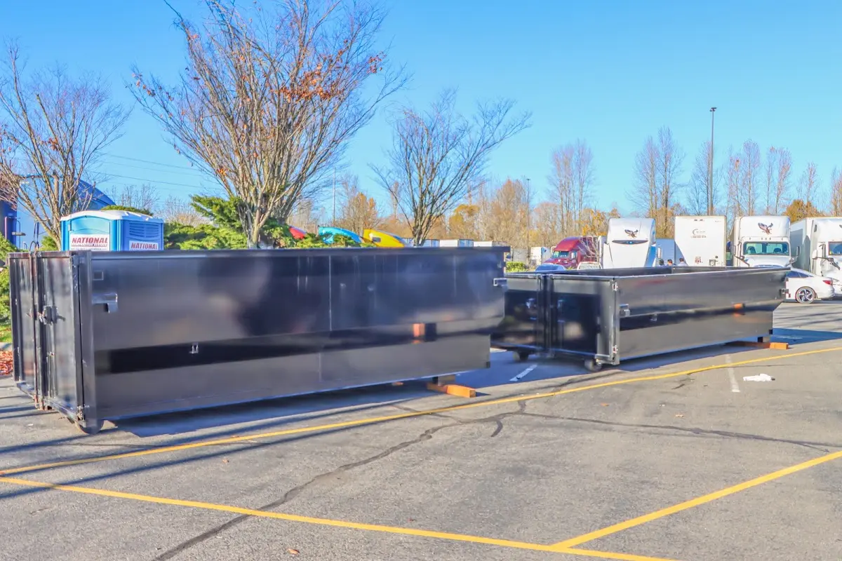 Professional dumpster rental service with roll-off container on residential driveway in Hollidaysburg